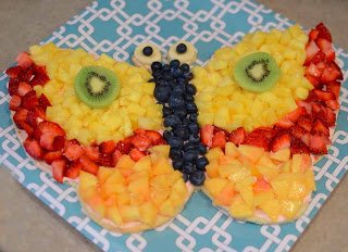 butterfly fruit pizza with pineapple, blueberries, kiwi, and more. 