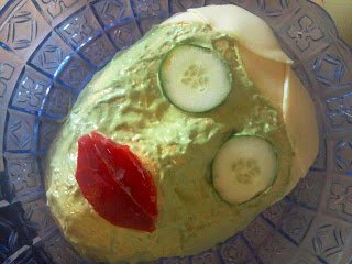 woman facial cheese ball with cucumbers over the eyes and red pepper lips. 