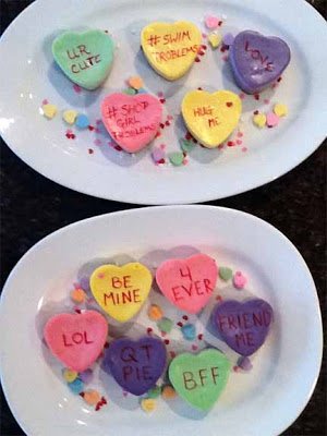 conversation heart cheesecakes on two white oval platters.