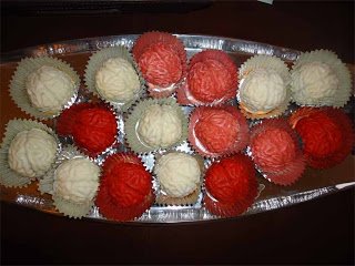 white and red cake ball brains on a platter.