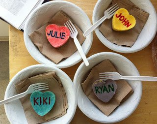 conversation heart cheesecakes in bowls with plastic forks. 