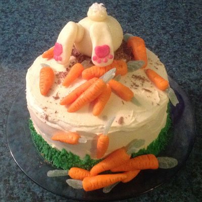 Adorably cute Bunny Butt Cake topped with modeling chocolate carrots.