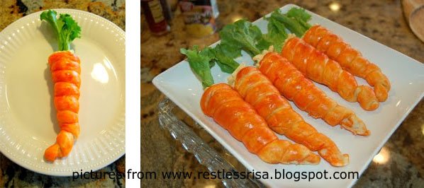 bright orange crescent roll carrots with lettuce leaf greens. 