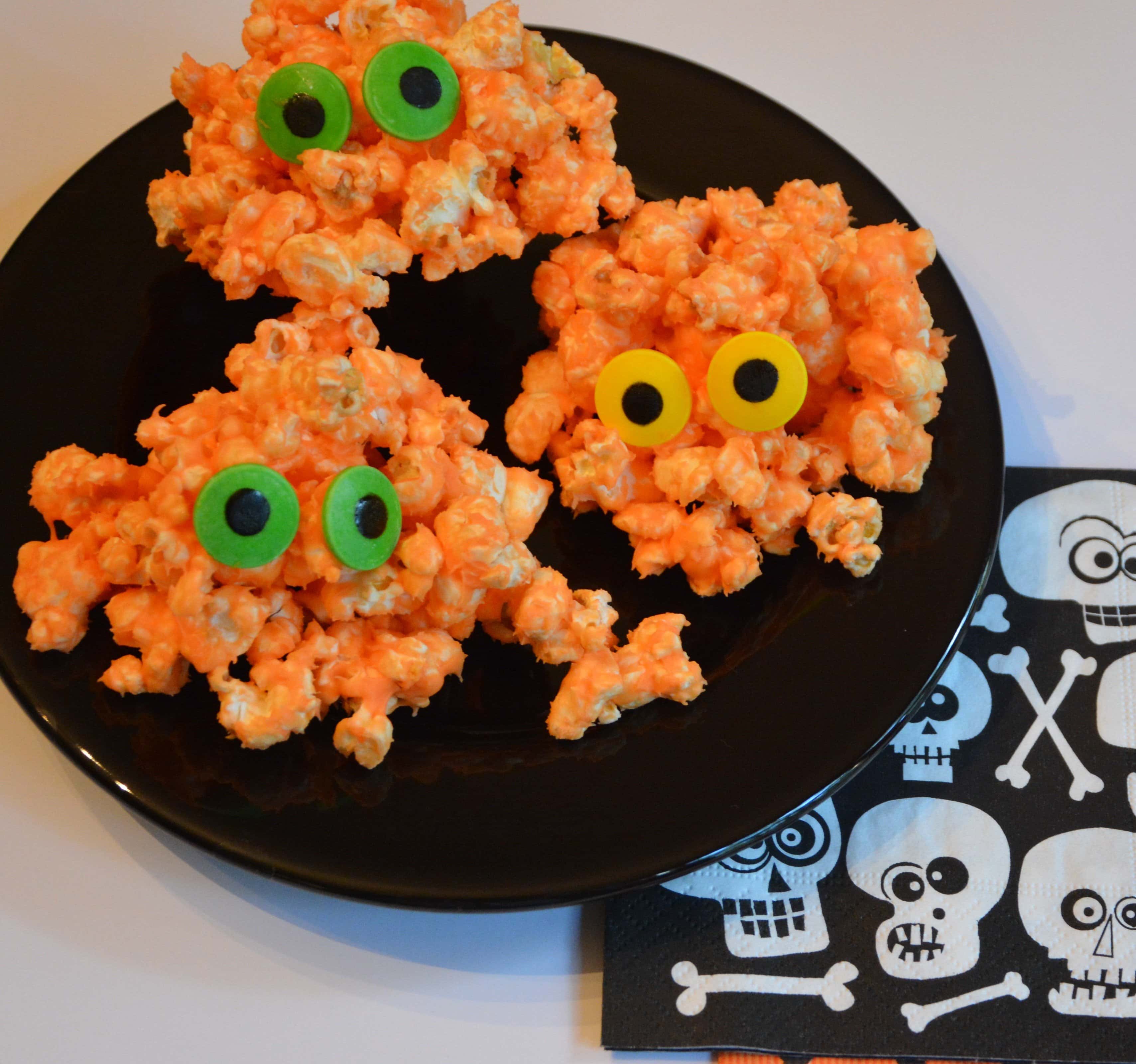Popcorn monsters with green and yellow candy eyes.