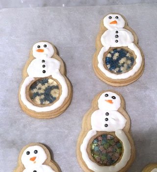 Snowflake sprinkle filled snowman cookies. Each snowman has a see through candy belly filled with snowflakes.
