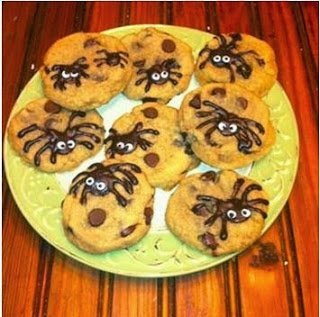 a plate filled with chocolate chip spider cookies. 