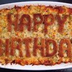 chicken artichoke bread pudding with Happy Birthday toast on top