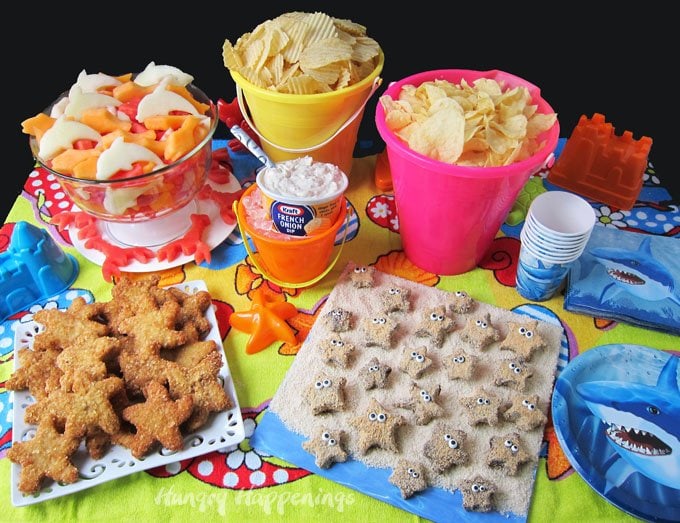 Make your beach party really amazing by serving Chip and Dip Chicken Starfish appetizers, Fish shaped fruit, and S'mores Starfish for dessert. Recipes at HungryHappenings.com