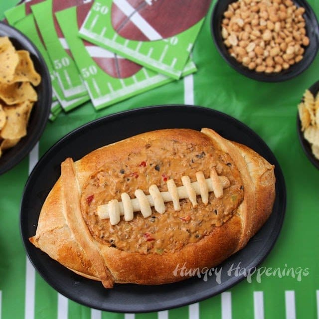 football bread bowl filled with taco dip