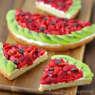 Wow your friends with this fun and festive Strawberry Kiwi Fruit Pizza Watermelon. It looks like a watermelon but tastes like dessert. Recipe from HungryHappenings.com