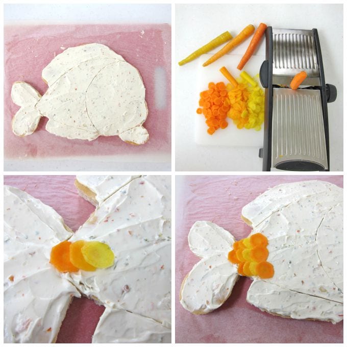 Slicing bright orange, light orange, and yellow orange carrots into thin slices using a mandoline and then arrange them on the fish-shaped pizza crust.
