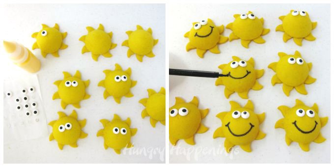 adding candy eyes and black food coloring smiles to sunshine cookies
