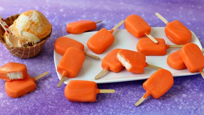 These treats are not made out of ice cream, but taste like a popular frozen treat. Take a bite into one of these Orange Creamsicle ™ Candy Pops and you'll find a creamy vanilla candy center surrounded by a silky orange candy coating. 
