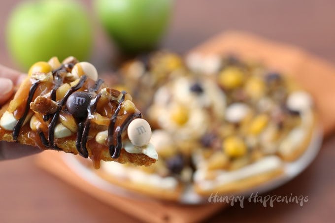 Did you know you can make nachos out of cake mix? Yep, these thin triangle chips are made from toasted cake layers and are topped with cream cheese fluff, glazed apples, chocolate and caramel sauce, toasted pecans, and Pecan Pie M&M