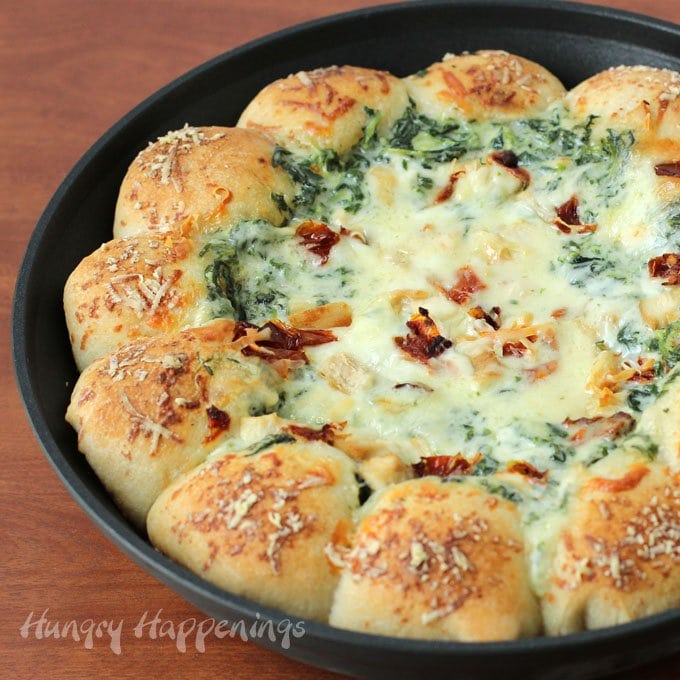 Break off a piece of mozzarella cheese filled pizza crust and scoop up some cream spinach alfredo dip and enjoy bits of chicken and bacon in every bite. 