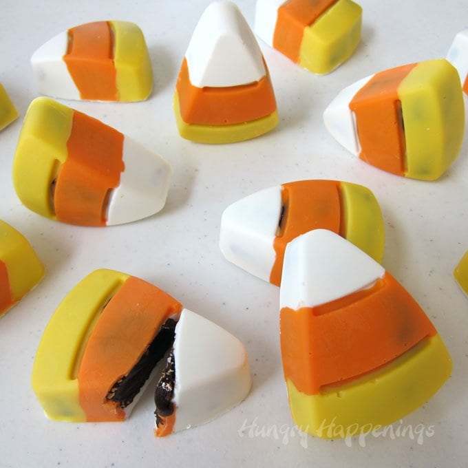 Handmade Chocolate Candy Corn Truffles are filled with soft and creamy dark chocolate ganache. Recipe from Hungry Happenings.