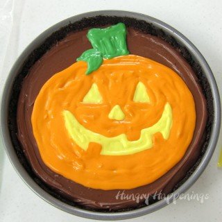 If you can draw a jack-o-lantern you can make this Painted Pumpkin Cheesecake for you Halloween party.