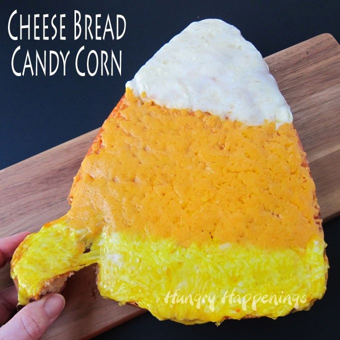 Top a candy corn shaped loaf of bread with yellow, orange, and white cheese to make a festive side dish for your Halloween dinner. See the recipe at Hungry Happenings.