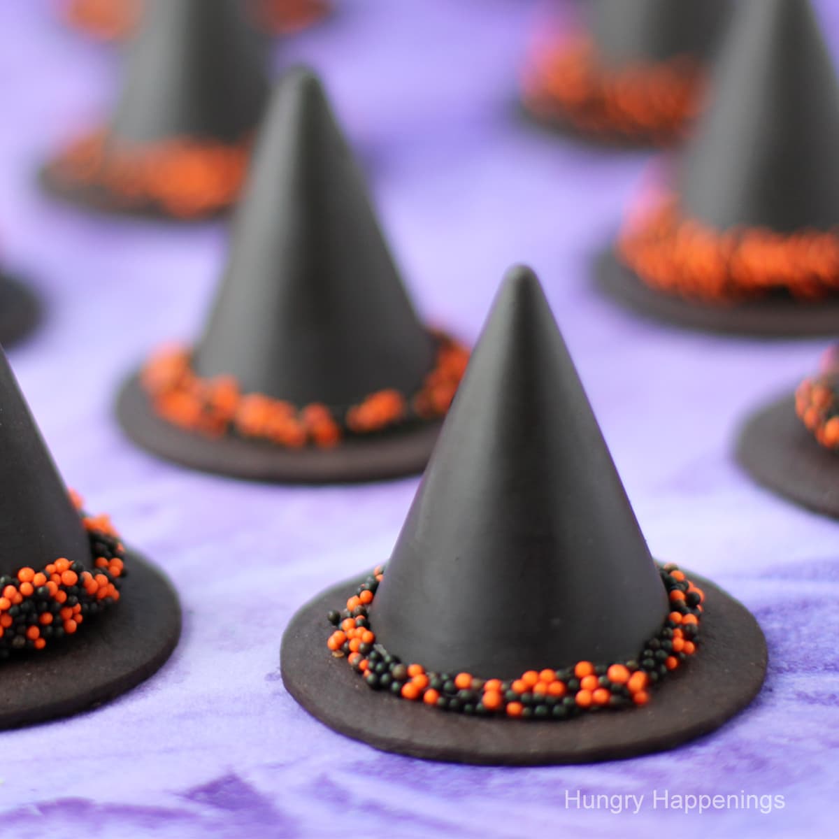 chocolate Nutella fudge witch hats with orange and black nonpareils hat band.