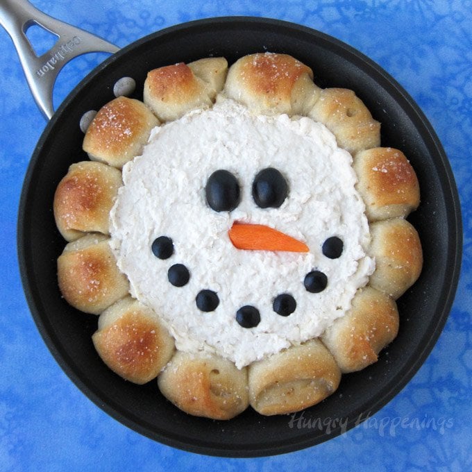 Warm the hearts and fill the bellies of your holiday party guests by serving a festive Christmas appetizer. When you pull this Skillet Dip Snowman out of the oven everyone will "ooh" and "ahh," before ripping off pieces of salty bread so they can scoop up the creamy chicken dip in the middle.