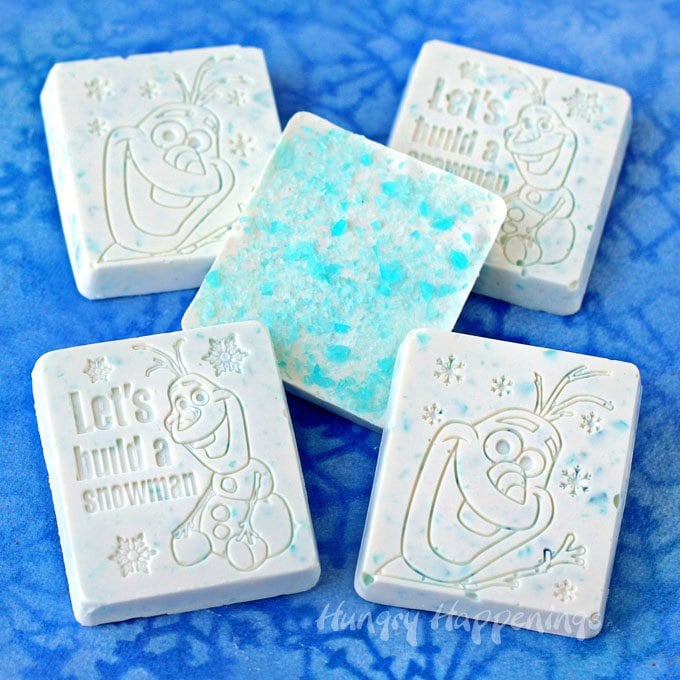 Crushed blue ice mints are added to white chocolate to make these cute Olaf Candy Bars. See the recipe at HungryHappenings.com.