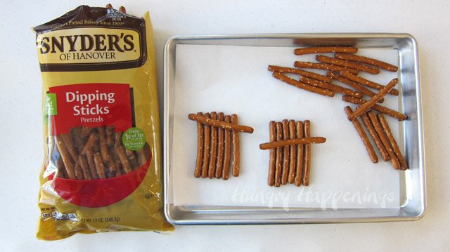 Use Snyder's of Hanover Pretzel Dipping Sticks to make cute Chocolate Pretzel Scarecrows. See how at HungryHappenings.com.