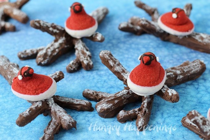 Red Velvet Peeps look like cardinals sitting in the snow, so I put them on top of snow covered chocolate caramel covered pretzel branches for some winter fun. See how you can make these yourself at HungryHappenings.com.