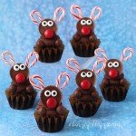 Decorate the ultimate chocolate cupcakes with peanut butter cup reindeer with candy cane antlers. See the tutorial at HungryHappenings.com.