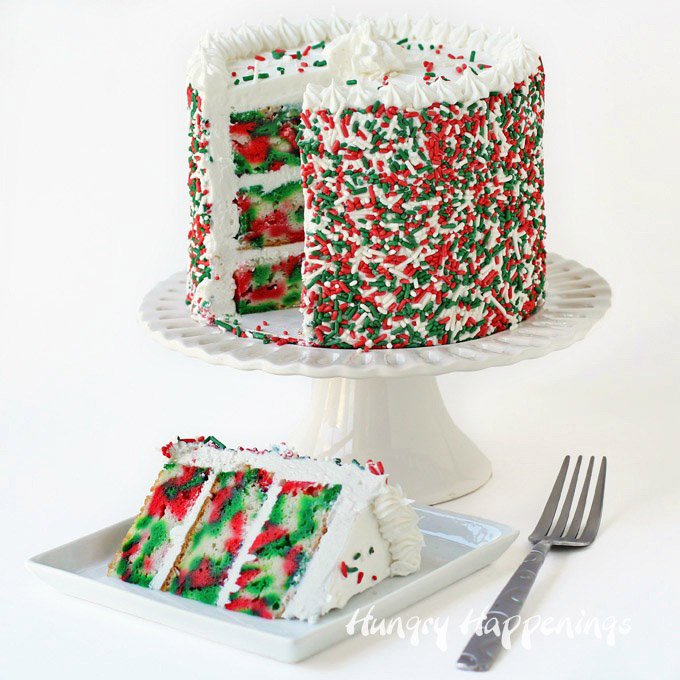 Three layer Tie-Dye Christmas Cake. Cut the first slice to reveal swirls of red, white and green color hiding inside. 