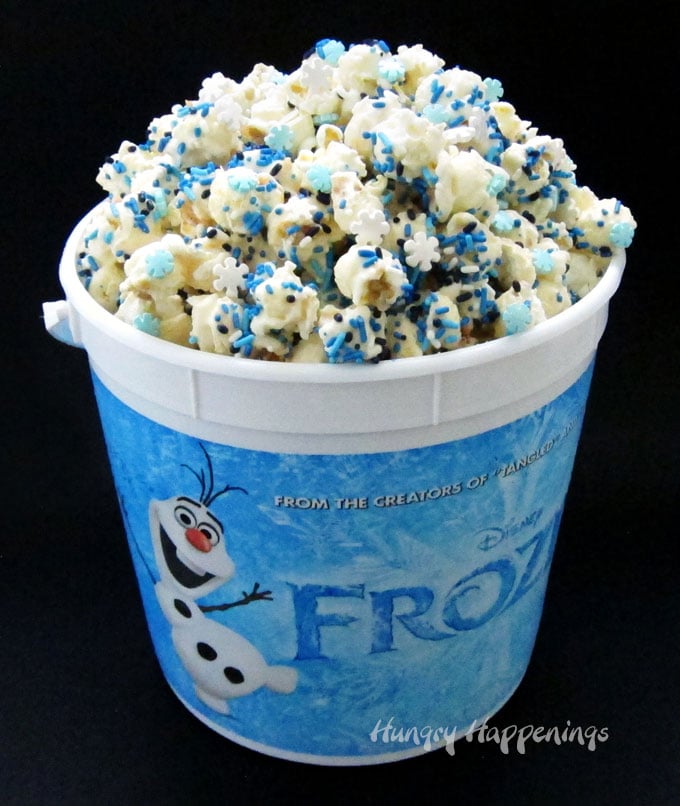 Snuggle up with your family and enjoy a movie night watching Disney's Frozen while munching on this fun snowflake sprinkle filled Frozen Popcorn.