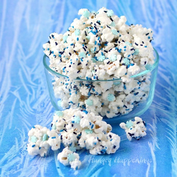 This Winter Wonderland White Chocolate Popcorn speckled with candy snowflakes and blue sprinkles would make a great treat for a Frozen party, a nice gift for Christmas, or a wintertime snack. 