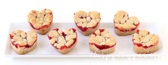 2 Ingredient Heart Shaped Cherry Pie Bars are a perfectly easy dessert to make for Valentine's Day. See just how easy they are to make at HungryHappenings.com.