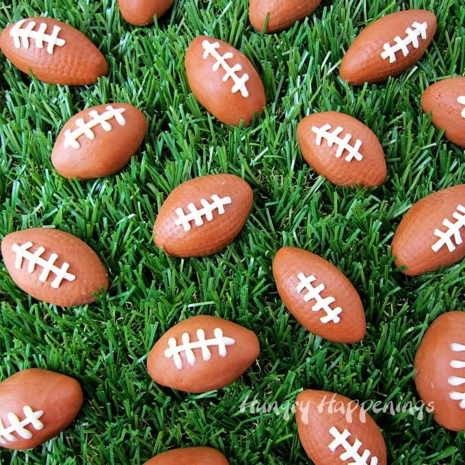 chocolate caramel fudge footballs arranged on green grass