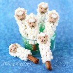 Dip pretzel rod halves in white chocolate then coat with marshmallows to create these sweet little Lamb Pretzel Pops. See how easy they are to make at HungryHappenings.com.