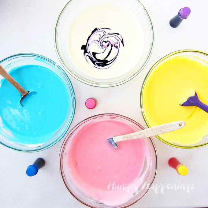 Color cheesecake filling blue, pink, yellow, and purple to make Tie-Dye Swirl Cheesecake Easter Eggs .