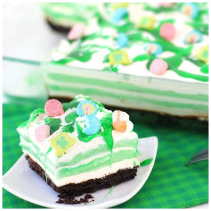 Layers of creme de menthe pudding, cream cheese fluff, and whipped cream are drizzles with Creme de Menthe and chocolate syrup. 