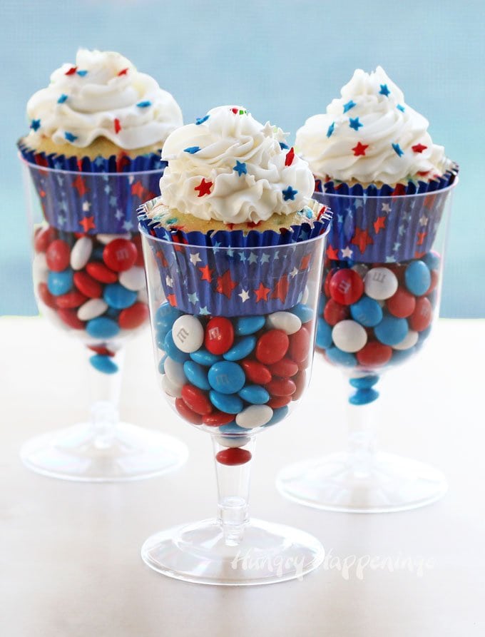 red, white, and blue cupcakes served in plastic wine glasses filled with 4th of July M&Ms