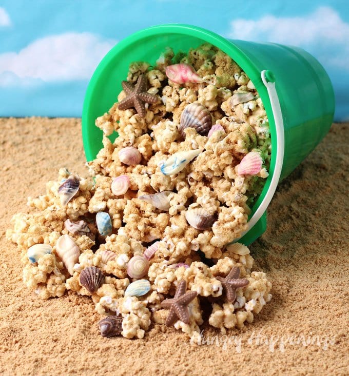 Beach Party Popcorn - Peanut Butter White Chocolate Popcorn Sprinkled with Sandy Cookie Crumbs and Chocolate Sea Shells
