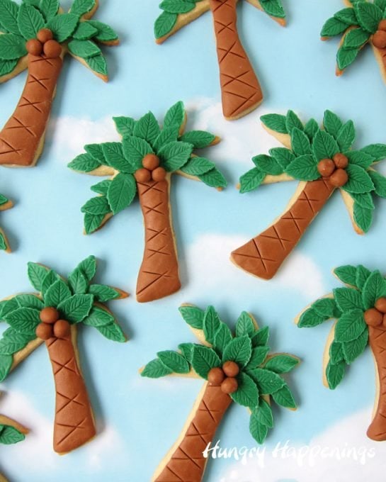 Decorate Palm Tree Cookies using modeling chocolate to give them texture including 3 dimensional coconuts. 