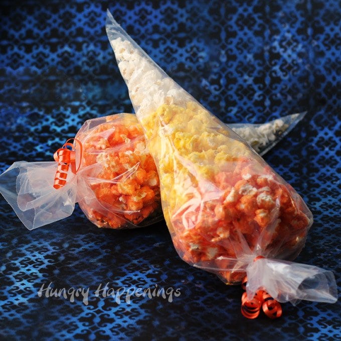 Dress up your popcorn to look like an iconic Halloween candy. Toss some popcorn in orange, yellow, and white Candy Melts and nestle the pieces in clear plastic cone shaped bags to create these festive Popcorn Candy Corn Bags. 