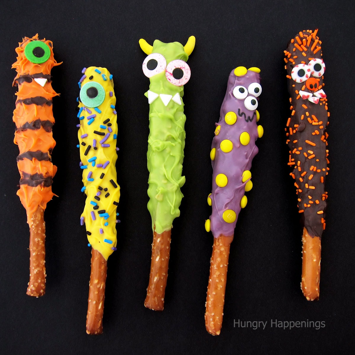 chocolate caramel pretzel monsters decorated with candy eyes, sprinkles, and mini candies. 