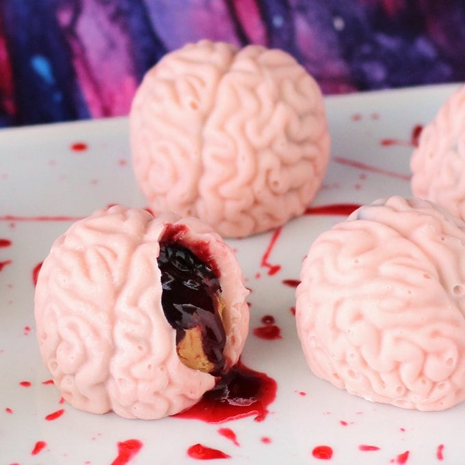 Creep out your friends and family this Halloween by serving them Bleeding PB&J Brains. They may look a bit gross but they are tasty peanut butter fudge and jelly filled candy brains.