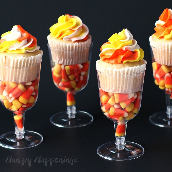 Pipe a pretty swirl of orange, yellow, and white frosting onto your cupcakes then nestle the cupcakes in plastic wine glasses filled with candy corn. These pretty Candy Corn Cupcakes are easy to make and will dress up your Halloween dessert table.
