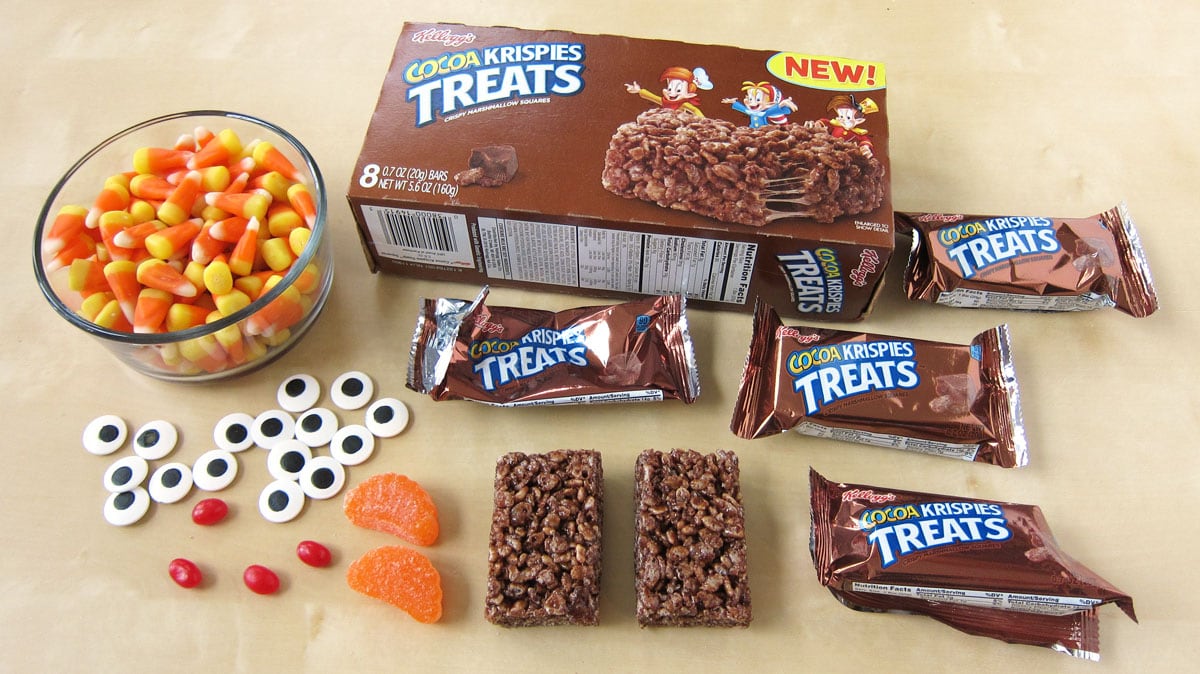 Cocoa Krispies Treat Turkeys ingredients including Kellogg's Cocoa Krispies Treats, orange slices, candy eyes, candy corn, and red jelly beans. 