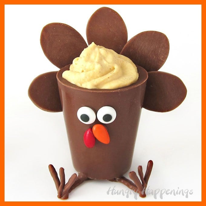 Surprise your party guests this Thanksgiving by serving these sweet little Chocolate Turkey Cups filled with Pumpkin Cheesecake Mousse. Watch the video tutorial to see how to make and decorate these holiday treats.