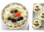 Decorate snowmen lasagna using olive eyes and carrot noses.