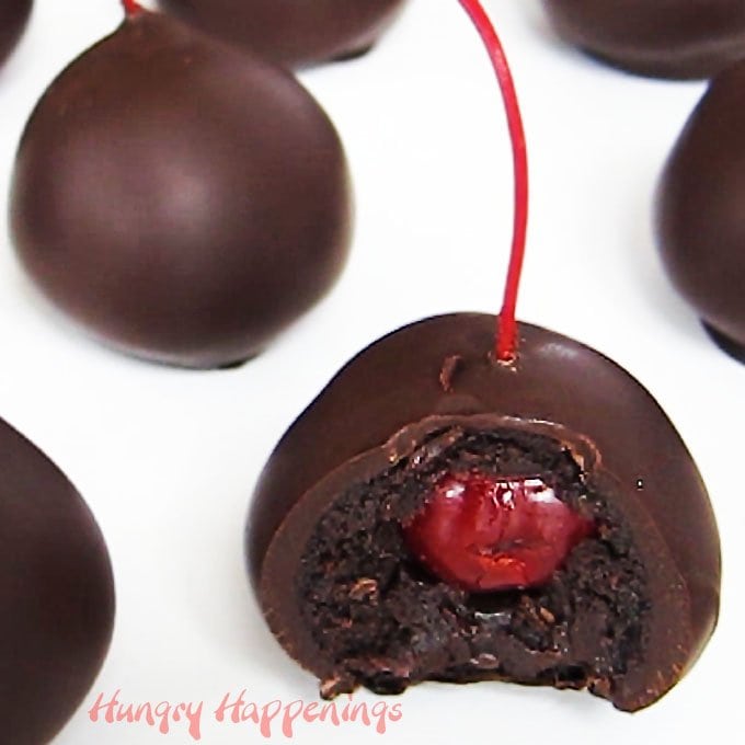 Chocolate Cherry Bombs with a maraschino cherry in the center of a chocolate cake ball.
