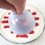 Dip a balloon into white chocolate with red stripes.