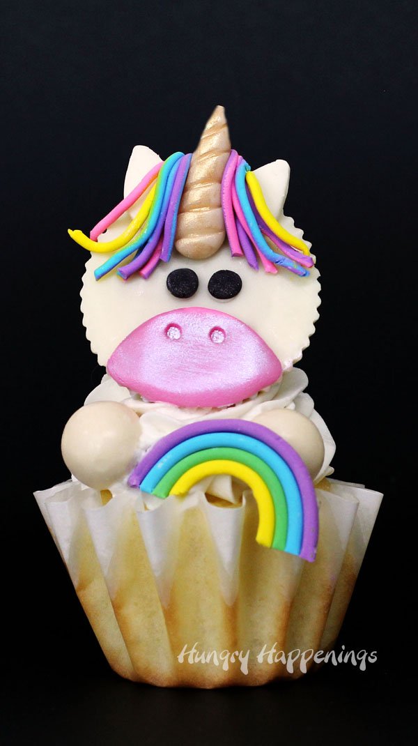 These Magical Unicorn Cupcakes made with White Reese's Cups and Candy Clay will be the hit of any birthday party. With their rainbow colored manes, gold candy horns, and expressive little eyes, these mythical creatures come to life in the sweetest form. 