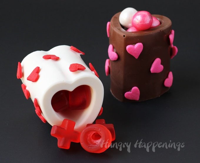 You won't believe how easy it is to make your own homemade Chocolate Heart Cups using a silicone mold. Just melt, fill, and chill then add some heart sprinkles to make them pretty and fill them with your favorite Valentine's Day candy. Kids and adults will love them.
